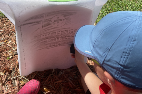 Student doing a headstone rubbing