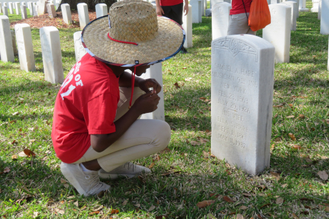 Student reading a headstone